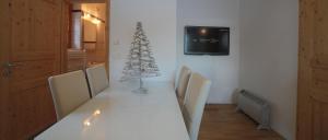 a white dining room table with a christmas tree on it at Apartment Brina in Kranjska Gora