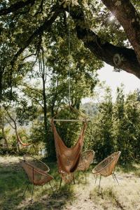 two chairs and a hammock hanging from a tree at Domaine S&B in Aubenas