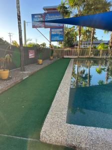 a artificial turf basketball court with a water slide at Kookaburra Holiday Park in Cardwell