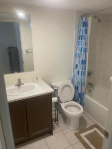 a bathroom with a sink and a toilet and a shower at Comfort King in Oshawa
