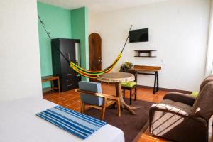 a living room with a hammock in a room at Casa San Jerónimo in Puerto Escondido