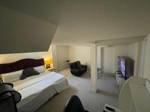 a bedroom with a bed and a chair and a television at Comfort King in Oshawa