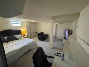 a bedroom with a bed and a desk and a chair at Comfort King in Oshawa +23 photos