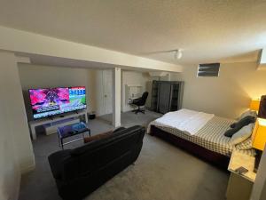 a bedroom with a bed and a flat screen tv at Comfort King in Oshawa