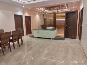 a bathroom with a sink and a table and chairs at Hotel Tamilnadu Rockfort Trichy in Tiruchirappalli +50 photos