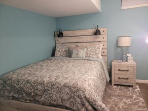 a bedroom with a bed with a wooden headboard at Blessings Private Home in Louisville