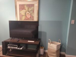 a living room with a tv and a coffee table at Blessings Private Home in Louisville