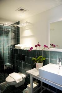 a bathroom with a sink and a toilet and a mirror at Peking Station Hostel in Beijing +49 photos