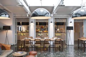 a dining room with a table and chairs at amba Taipei Ximending in Taipei
