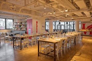 a row of tables and chairs in a room at amba Taipei Ximending in Taipei