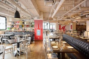 a restaurant with tables and chairs and a red refrigerator at amba Taipei Ximending in Taipei +22 photos