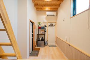 a hallway with a staircase in a house at NEW OPEN! HOTEL Kozafornia in Okinawa City