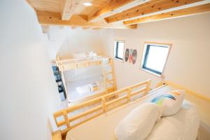 a small room with a bed and wooden ceilings at NEW OPEN! HOTEL Kozafornia in Okinawa City