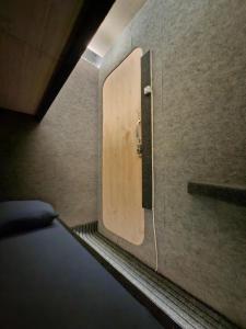 a room with a door in the corner of a room at Capsule room with aircon in Manila
