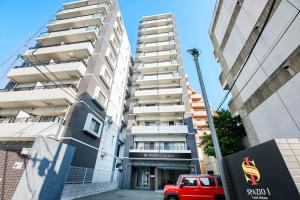 a red truck parked in front of a tall building at SPAZIO 1 Canal Hakata Annex in Sumiyoshi +30 photos