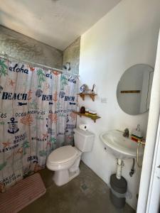 a bathroom with a toilet and a sink and a mirror at Green Tree El Paredon in El Paredón Buena Vista +10 photos