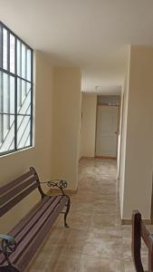 a empty hallway with a bench and a window at La casa de Manuel in Lunahuaná +5 photos