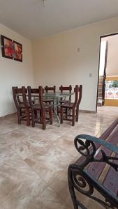 a dining room with a table and wooden chairs at La casa de Manuel in Lunahuaná