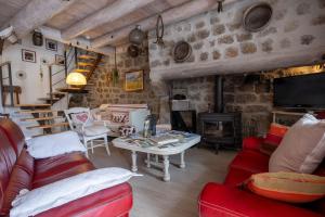 a living room with red furniture and a fireplace at Gîte oya in Chaudeyrac