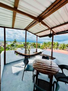 a patio with a table and chairs and a view of the ocean at PROMOCIOn VILLA PRIVADA SPRING in Puerto Ayora