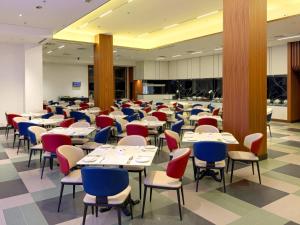 a dining room with tables and chairs at Lexis Port Dickson in Port Dickson