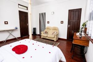 a bedroom with a bed and a chair at Hilltop Retreat Matale in Matale