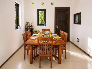 a dining room with a wooden table and chairs at Hilltop Retreat Matale in Matale