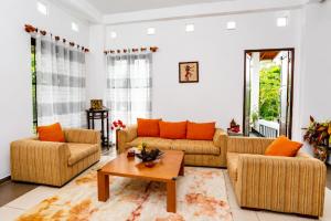 a living room with two couches and a coffee table at Hilltop Retreat Matale in Matale +32 photos