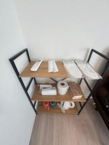 a small table with a remote control on top of it at New Happy Smile-Self Check In in Tokyo