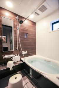 a bathroom with a tub and a toilet at こだま屋 in Tokyo