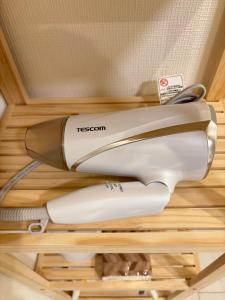 a hair dryer sitting on top of a shelf at New Happy Smile-Self Check In in Tokyo +35 photos