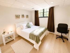 a bedroom with a bed and a desk and a chair at Elegant Boutique Stay in Lilburn
