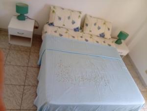 a bedroom with a bed with a blue cover on it at Casa Torre in Fiumefreddo Bruzio