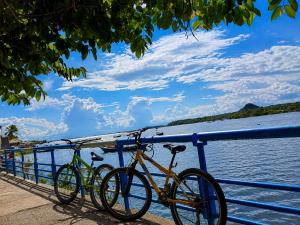 two bikes parked on a railing next to the water at Bela Vista Pousada Alter in Alter do Chao