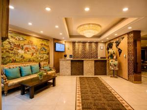 a living room with a couch and a table at Kentavr Hotel in Ulaanbaatar