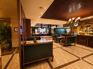 a lobby with a bar and a restaurant at Kentavr Hotel in Ulaanbaatar