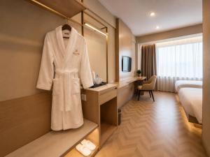 a hotel room with a robe on a mirror at Kentavr Hotel in Ulaanbaatar +11 photos