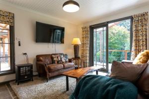 a living room with a couch and a table at The Bower at Wildside Sanctuary in Bilpin
