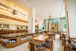 a restaurant with tables and chairs and a bar at Lanna Palace 2004 in Chiang Mai