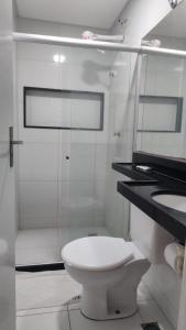 a white bathroom with a toilet and a shower at Pousada Recife Tropical in Recife +16 photos