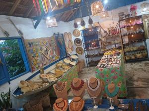 a store with a display of hats and baskets at Bela Vista Pousada Alter in Alter do Chao