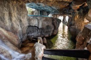 a cave in a rock wall with water in it at Holiday World Resort, Affiliated by Melia in Benalmádena