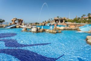 a water slide at a water park with a fountain at Holiday World Resort, Affiliated by Melia in Benalmádena +36 photos