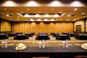 a large banquet hall with tables and bottles of water at Hotel Olive in Tangerang
