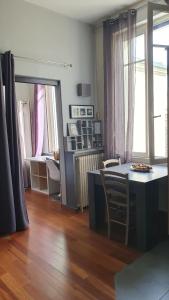 a living room with a table and chairs and a desk at RESIDENCE HERMITAGE LE TOUQUET in Le Touquet-Paris-Plage