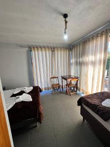 a bedroom with a table and a bed and a table at Pousada Bonetti Quarto 9 in Santa Rosa