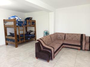 a living room with a couch and a bunk bed at Casa Rústica Diaz in Ica