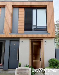 a house with a wooden door and windows at The Elegant Corner in Wellington