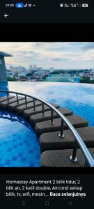 a poster of a swimming pool with a picture of the water at EM Suite Home 2Bedroom Dperdana Apartment in Kota Bharu