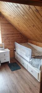 a bedroom with a bed and a wooden ceiling at Bacówka pod Ślężą in Sulistrowice